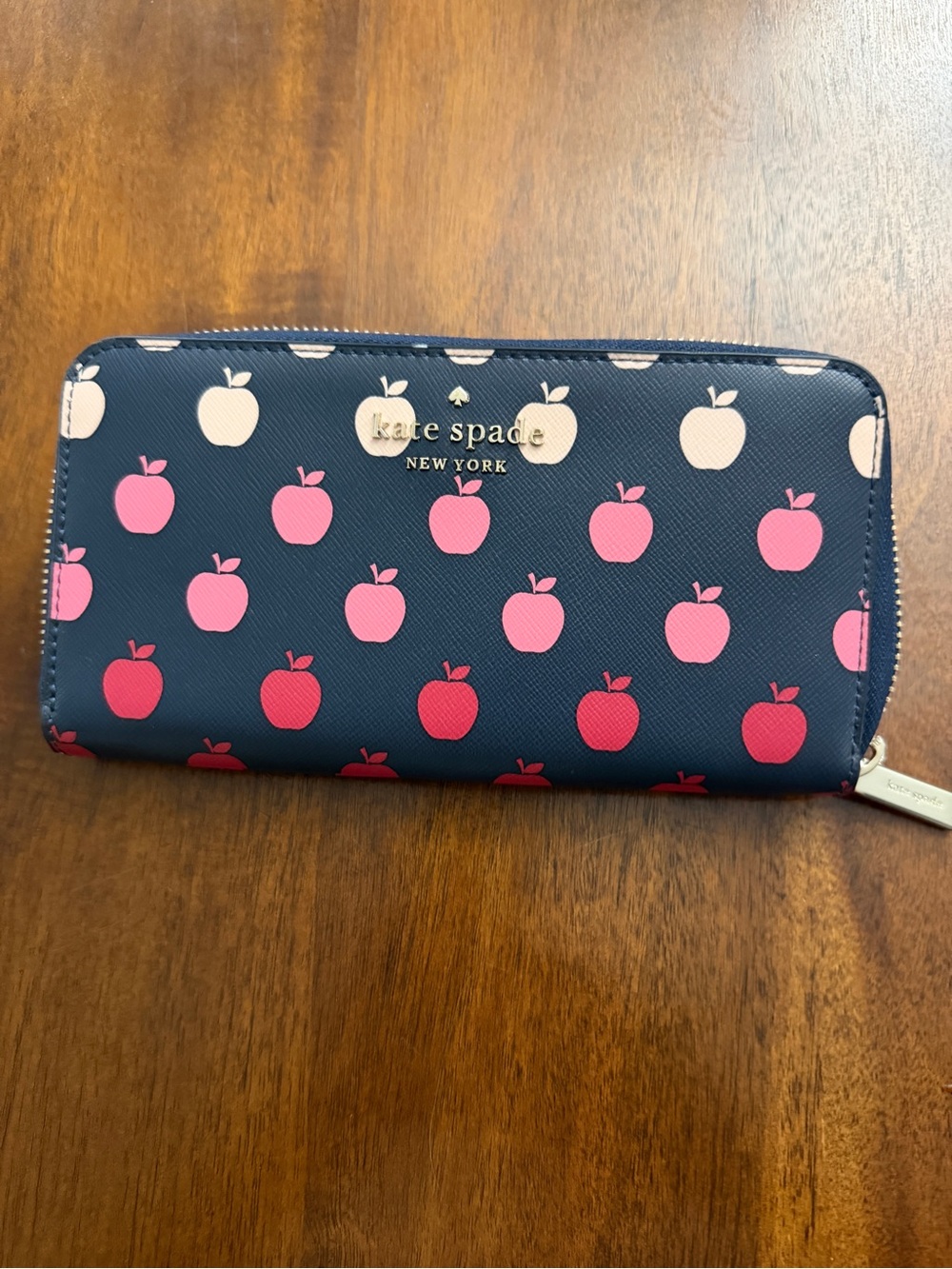kate spade navy wallet with pink and red apple pattern